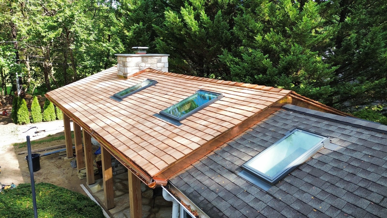 Phase 1 — sunroom roof still in asphalt shingles next to the new cedar shake porch, Bryn Athyn PA