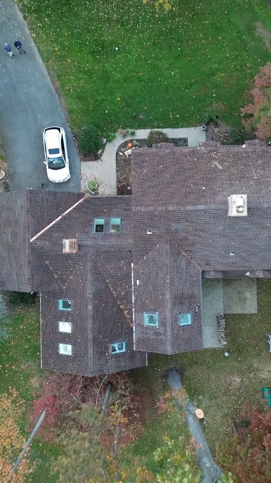 Drone view from above of a finished replacement shingle roof on a home in Ivyland, PA after storm tree damage, Shelby Roofing Services video