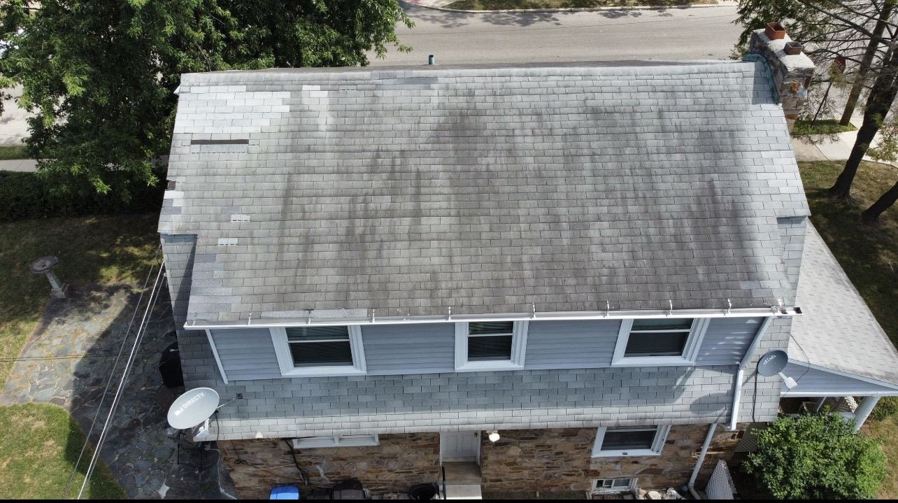 Before — aerial top-down view of algae-streaked gray shingles on stone colonial, PA