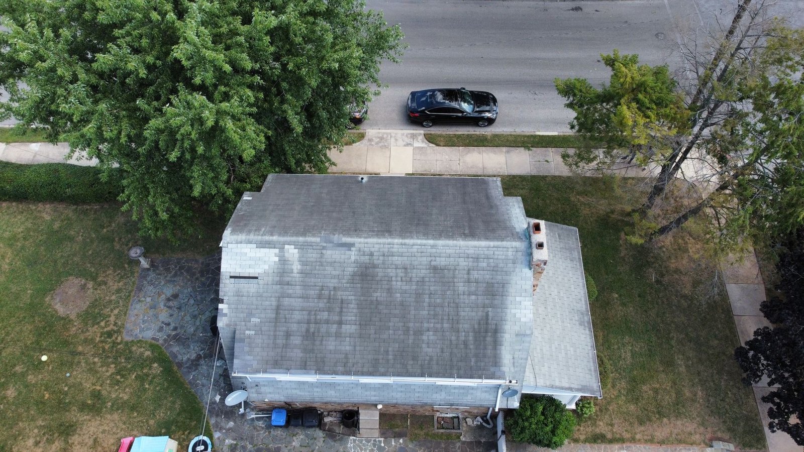 Before — wider top-down drone view of algae-streaked roof, PA