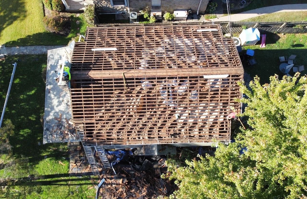 In-progress — full shingle tear-off showing bare roof decking, PA