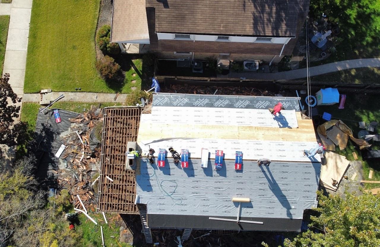 In-progress — crew installing new roof decking over tear-off, PA