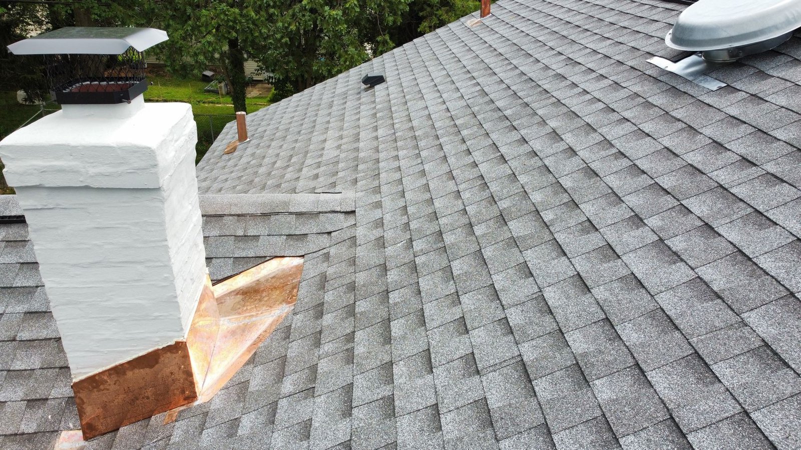 After — chimney with new copper flashing on completed shingle roof — Shelby Roofing Services PA