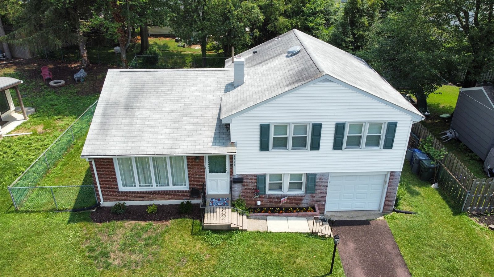 After — full front facade aerial showing completed charcoal shingle replacement — Shelby Roofing Services PA