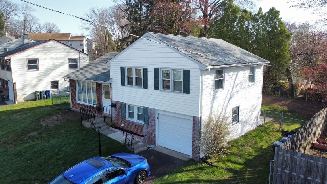 Before — front-right aerial view of home with old gray shingles and green shutters, PA