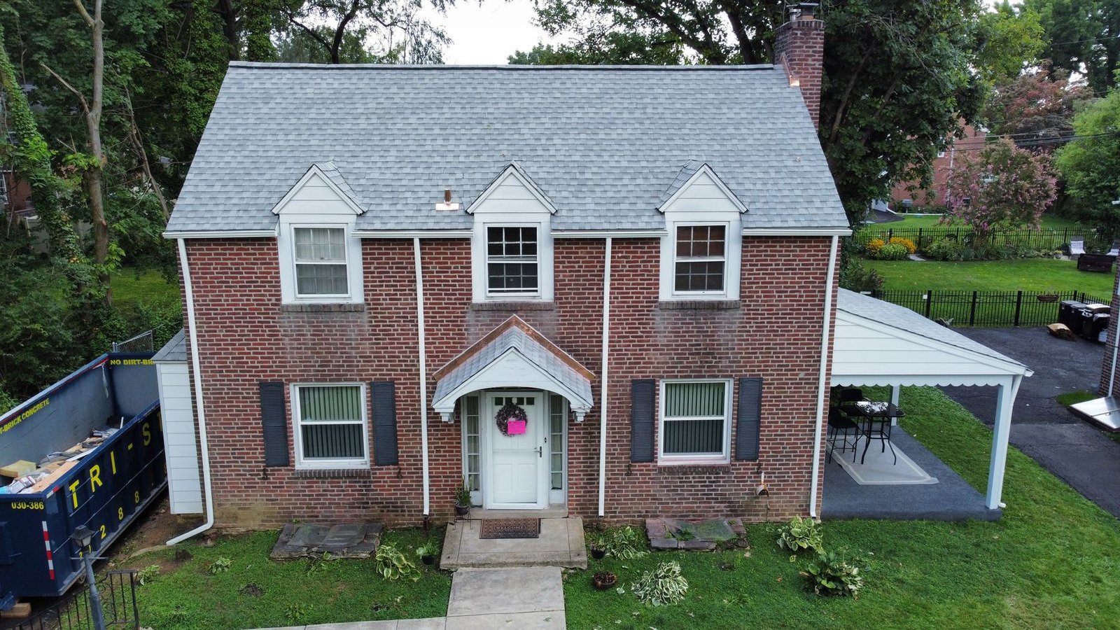 After — front facade aerial of brick colonial with new dimensional gray shingles — Shelby Roofing Services PA