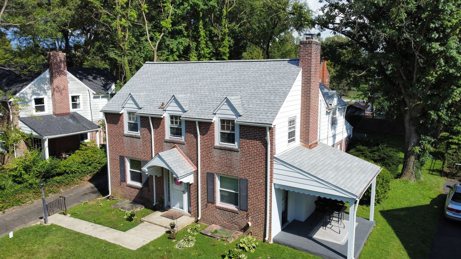 After — front-right aerial of completed roof with carport and new shingles throughout — Shelby Roofing Services PA