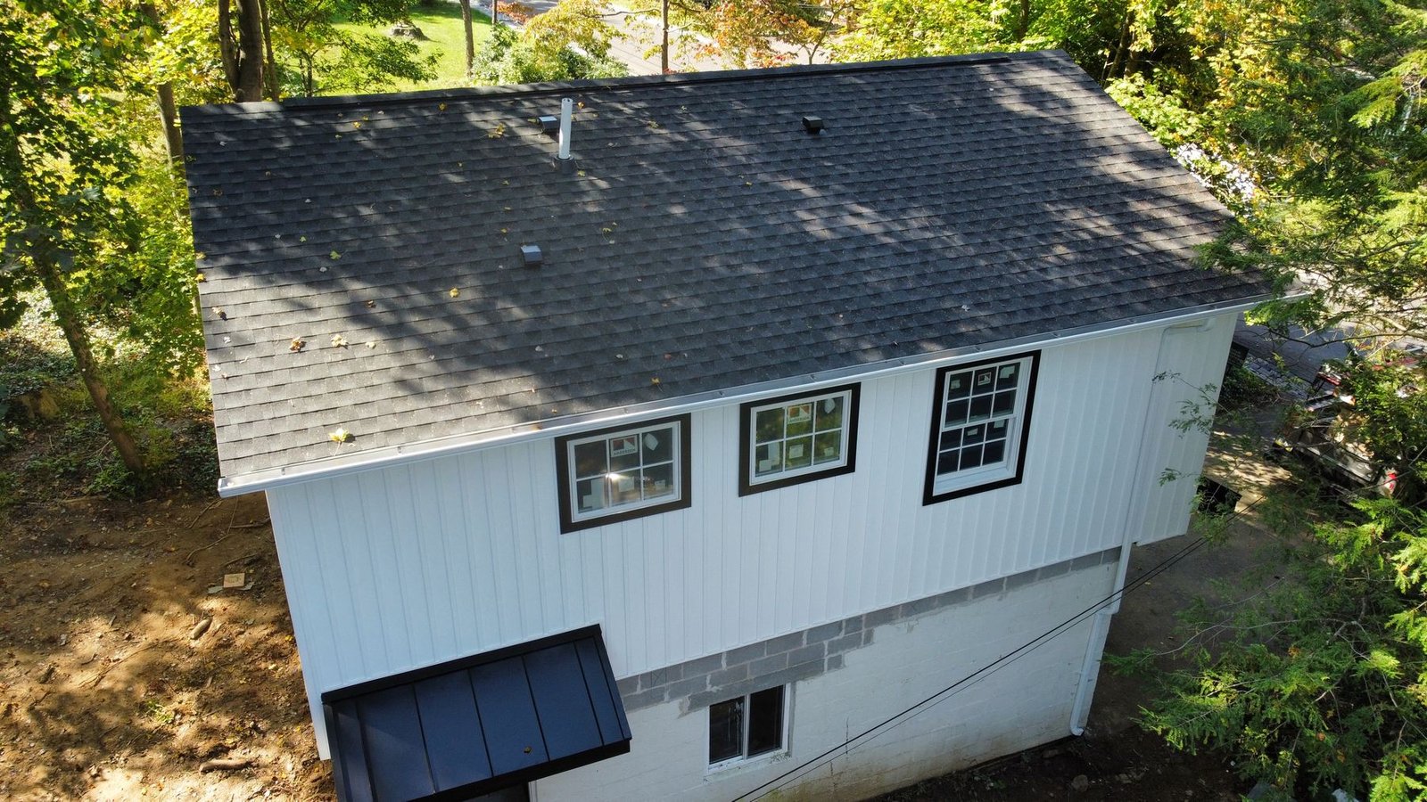 After — front-left aerial showing completed new construction with full roofing system — Shelby Roofing Services PA