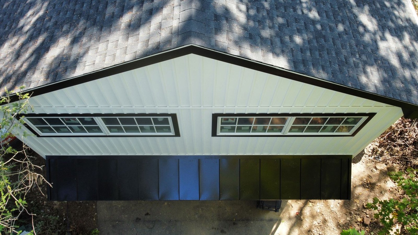 After — top-down aerial showing completed charcoal shingle roof and new white siding — Shelby Roofing Services PA