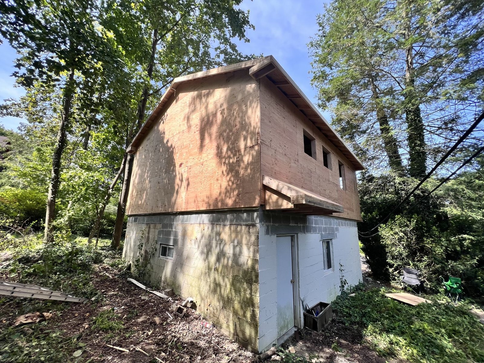 Before — side view showing bare roof framing and OSB sheathing during new construction, PA