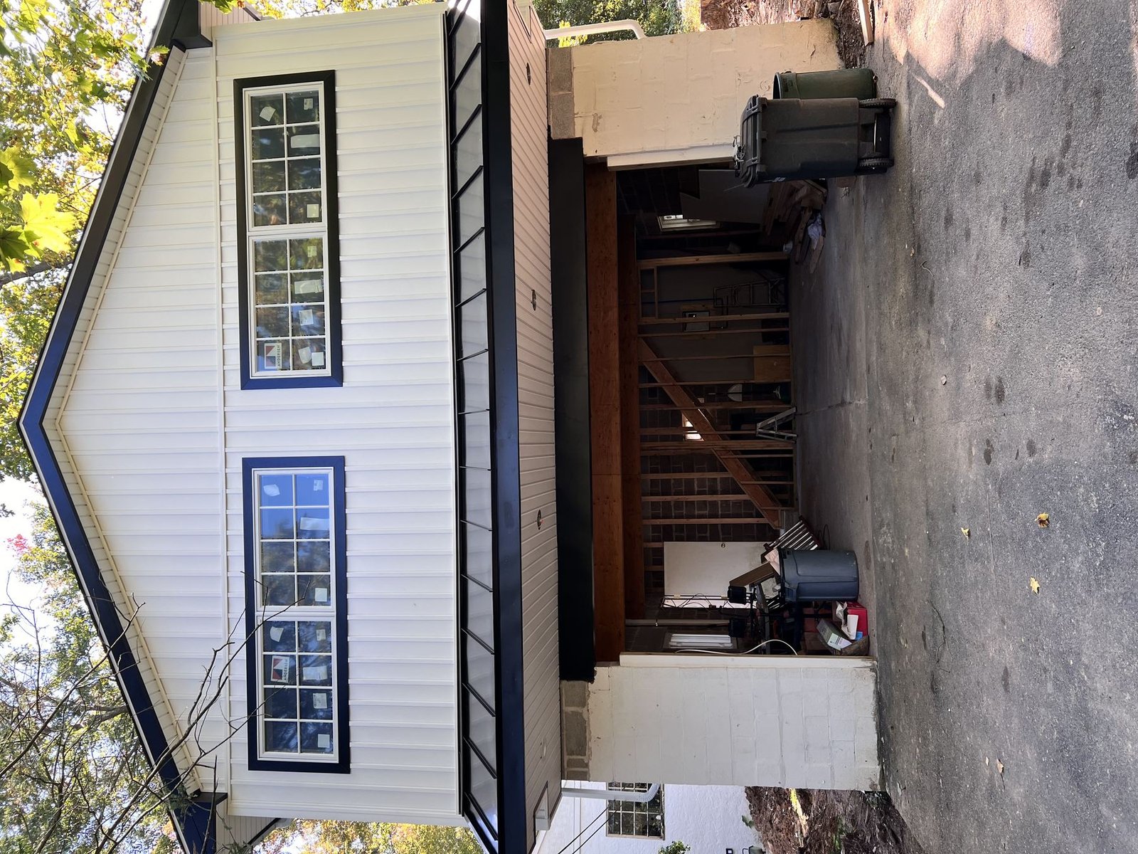 In-progress — partial completion showing new siding on one side, construction still active on other, PA