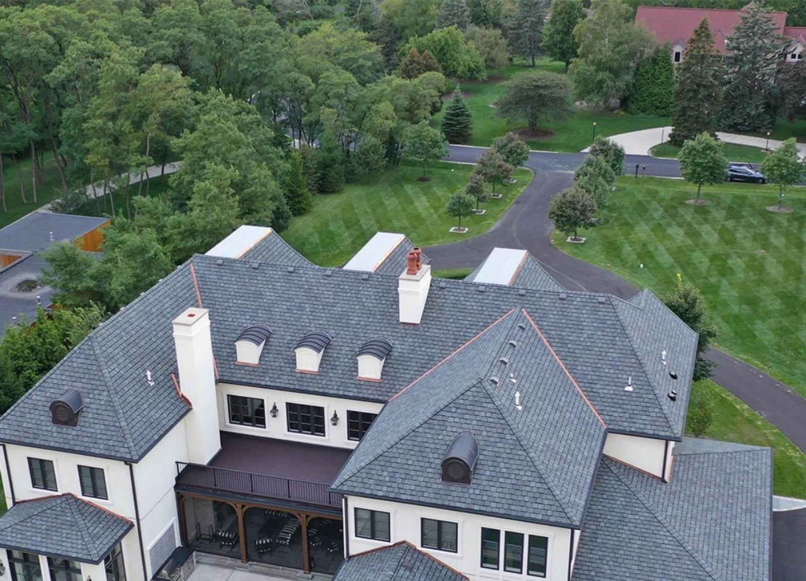 Completed shingle roof with copper flashing on a large estate home — Shelby Roofing Services