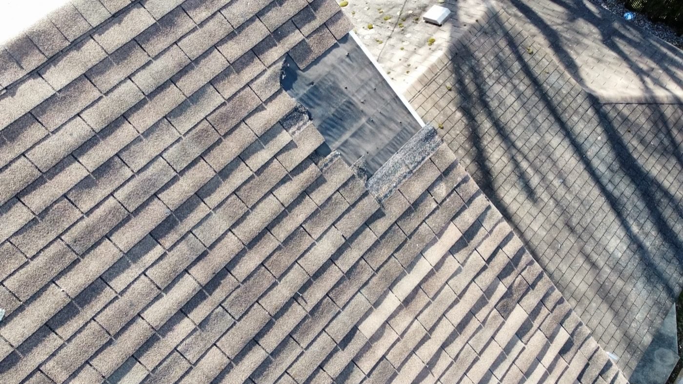 Drone inspection showing torn and missing shingles — Shelby Roofing Services