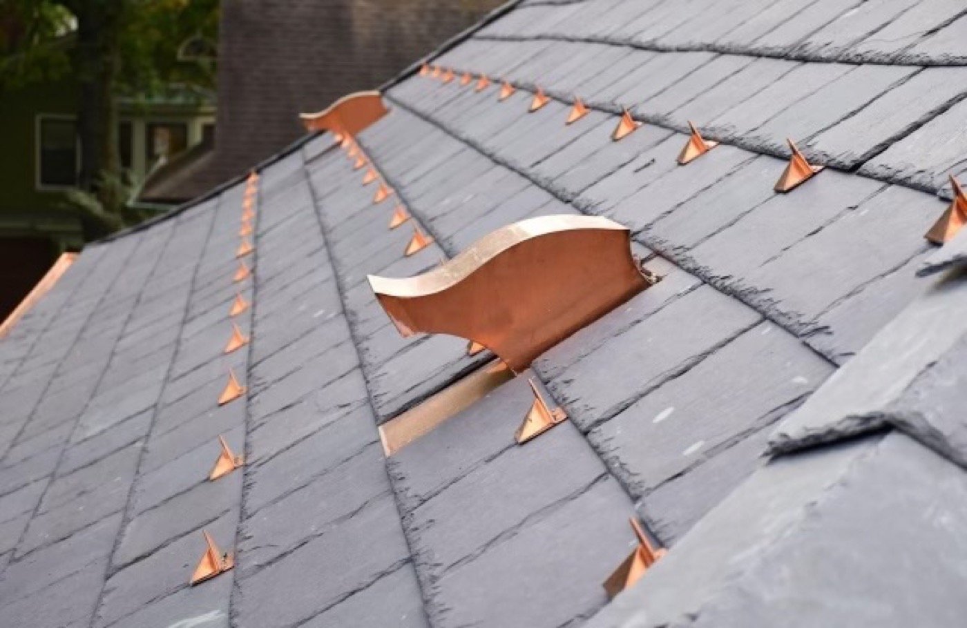 Natural slate roof tiles with copper snow guards — precision fastening at every course by Shelby Roofing Services