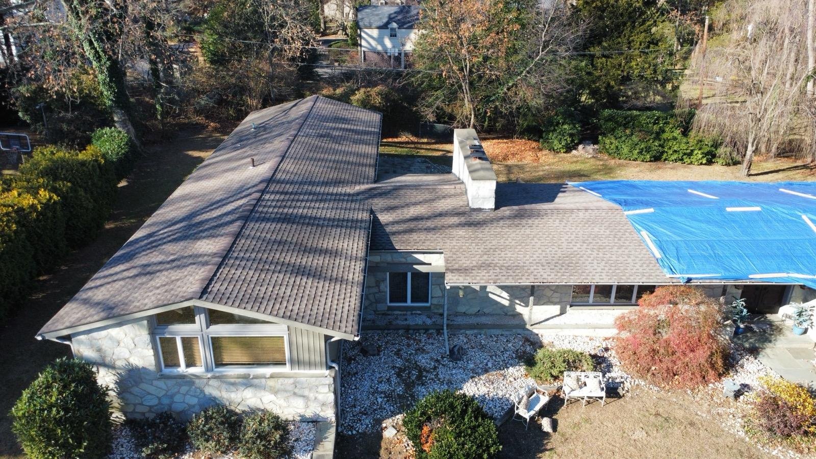 Storm damage tarp and partial roof restoration in progress